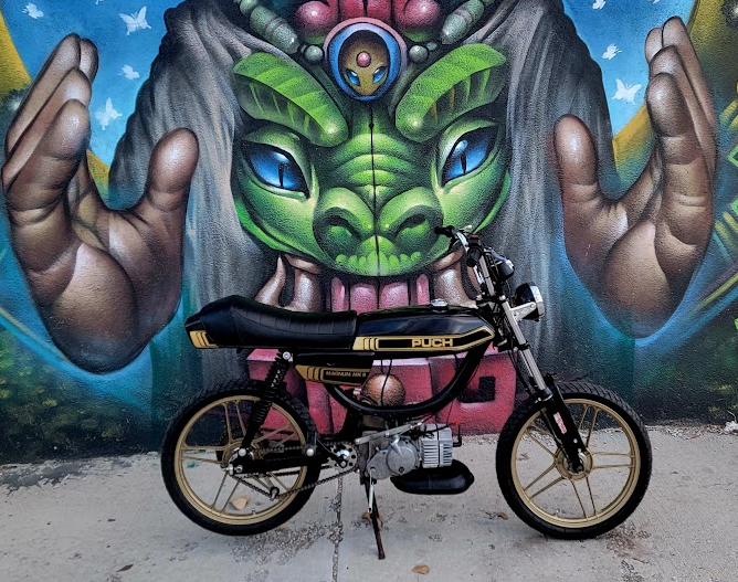 1980 Puch Magnum black and gold, mural backdrop