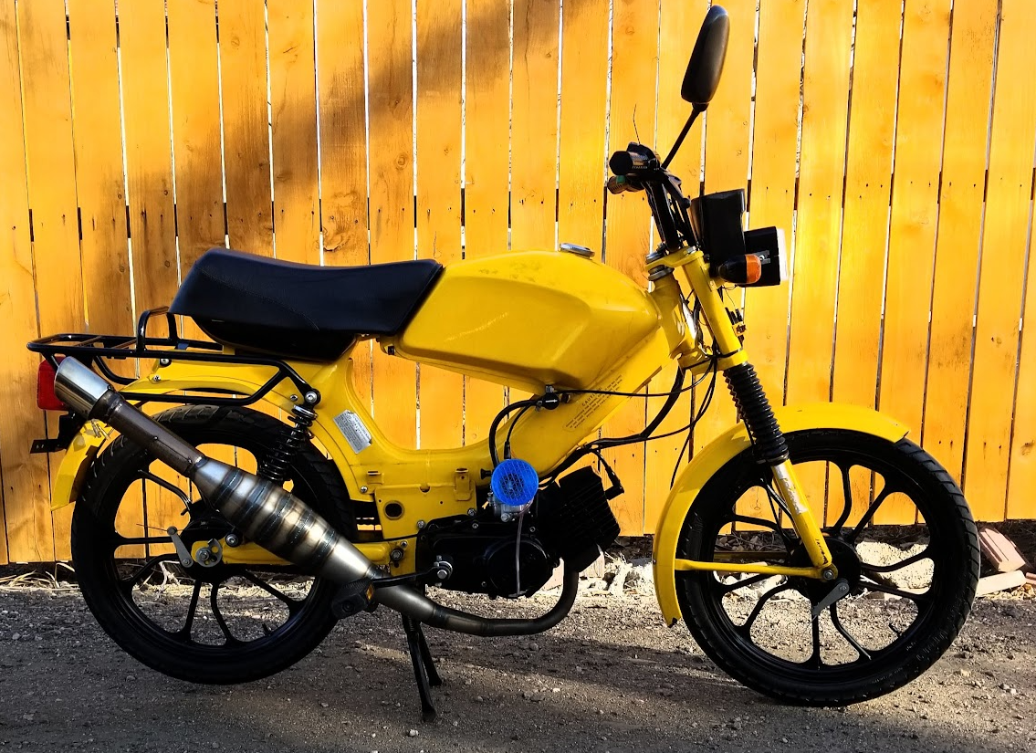 2002 Tomos LX, yellow, wood fence backdrop